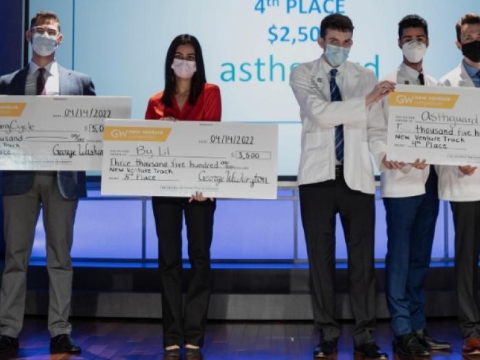 Picture of all the NVC Winners holding checks